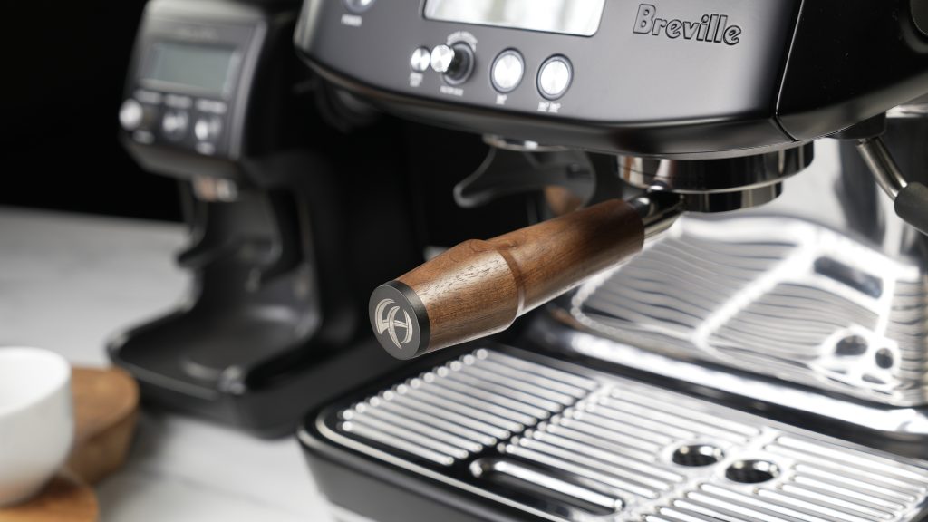 Walnut handled portafilter fitted to a Breville espresso machine