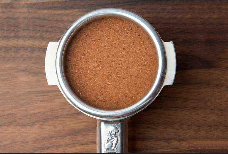 8. When the distribution side is set to the correct depth you will gently redistribute coffee grounds creating a smooth evenly distributed puck with no empty spots and minimal compression.