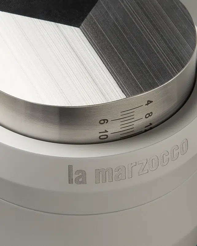 Faceted steel top and depth scale on the white La Marzocco leveller