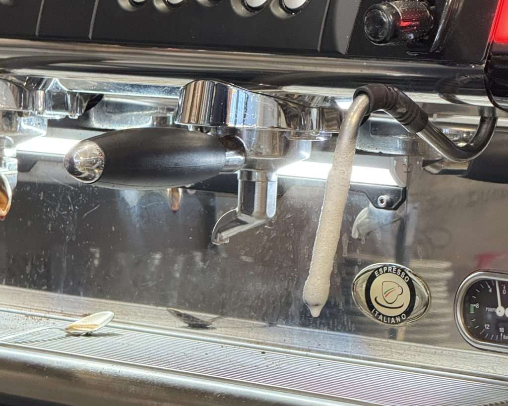 a Steam wand that is dirty
