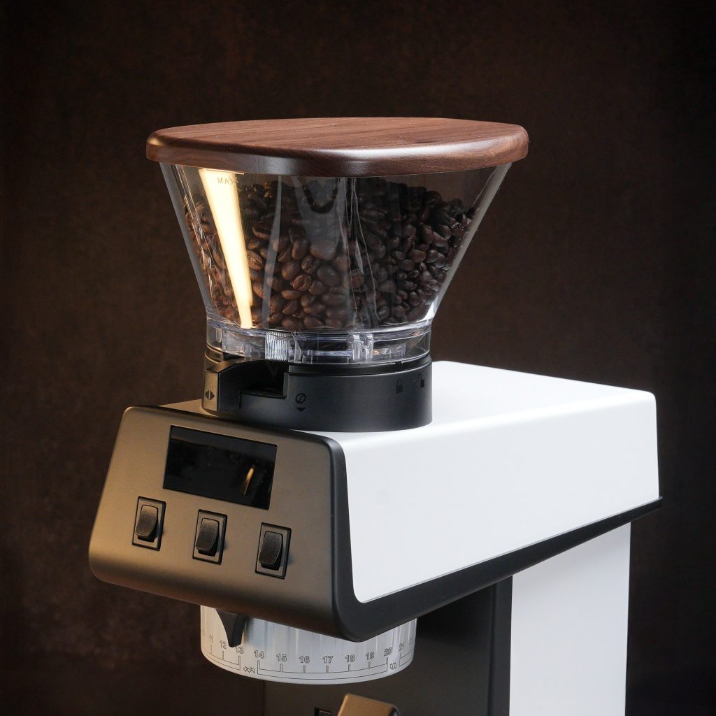 Artpresso walnut hopper lid in place on a white La Marzocco Pico grinder, shown with the display and dosing controls