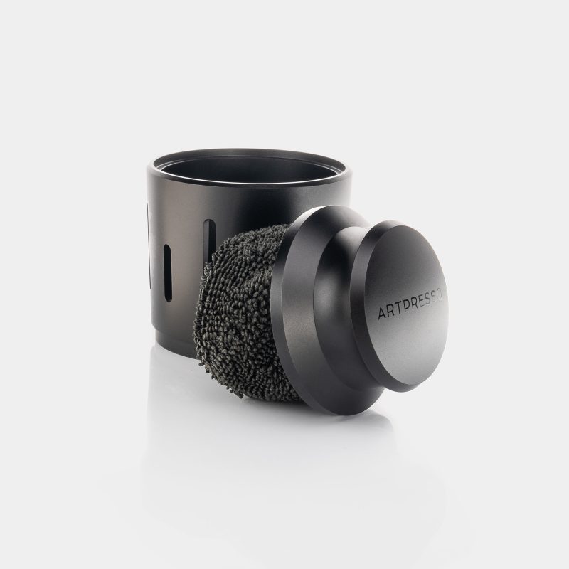Portafilter Pro Cleaning Tool fitted with its microfiber cover, resting against the slotted tool holder
