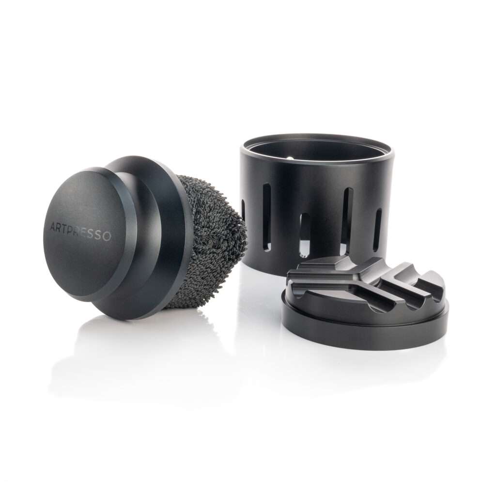a black round object with a round object on a white background called portafilter cleaning tool
