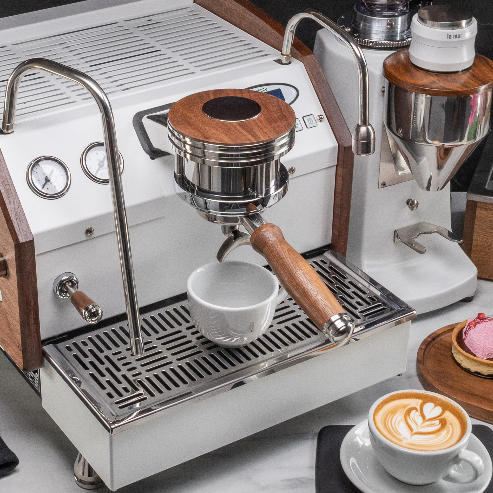 White La Marzocco Linea Mini with Artpresso walnut side panels, walnut portafilter handle and dosing funnel, beside a walnut-topped grinder