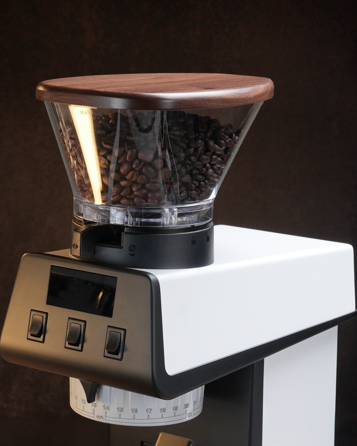 Artpresso walnut hopper lid fitted to a La Marzocco Pico grinder, coffee beans visible through the hopper