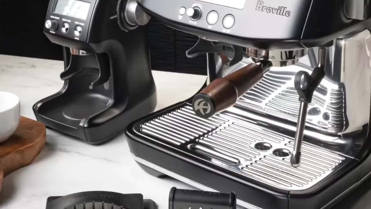 The Artpresso drain tray cleaning tool being drawn across the grate of a Breville espresso machine