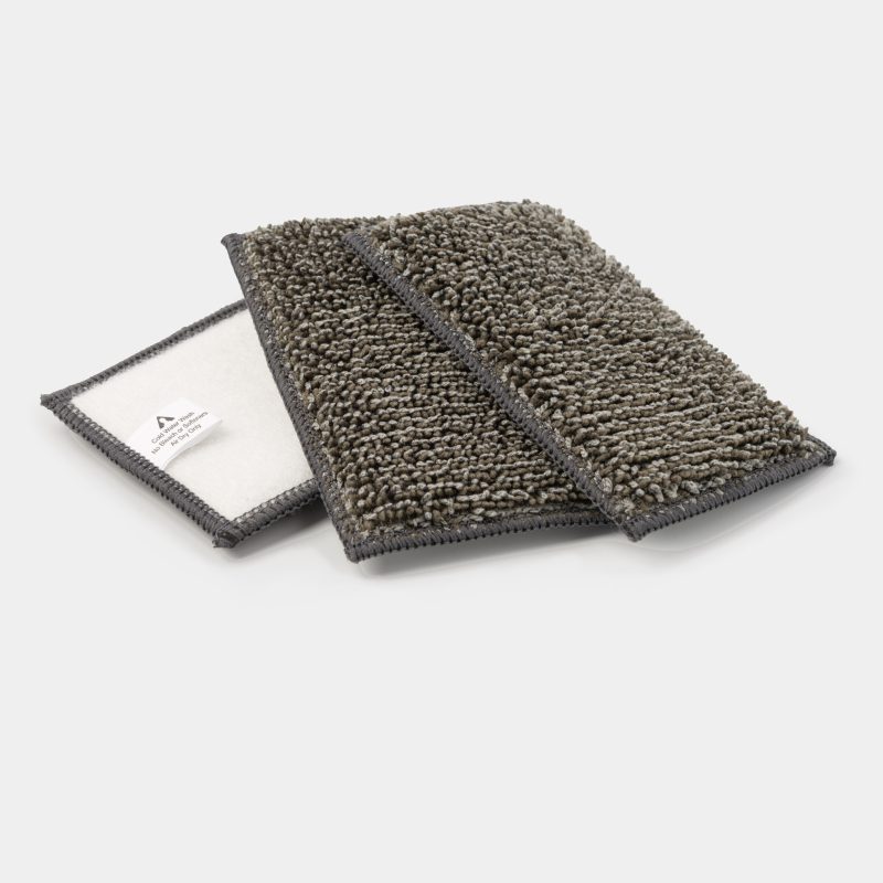 Drain Tray Pro replacement pad showing its white backing and care label, with a second pad chenille side up