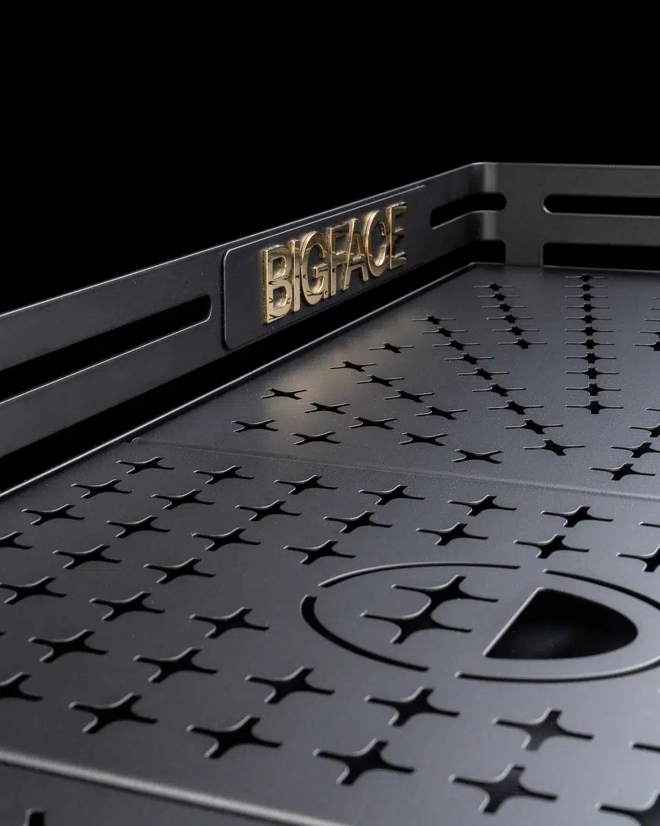 Black star-perforated cup tray on the BIGFACE La Marzocco Leva with a raised gold BIGFACE nameplate on the rail