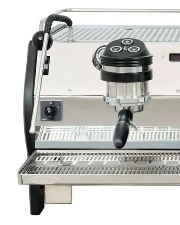 Corner detail of a standard three-group La Marzocco Strada, stainless front panel with one group head and portafilter