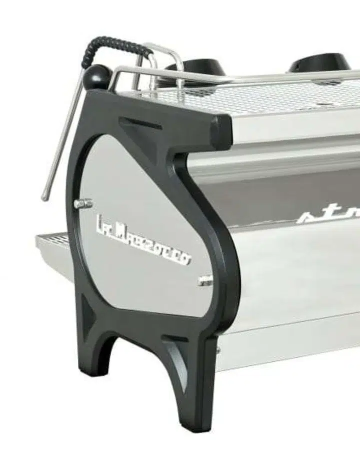 Corner detail of a standard La Marzocco Strada from the rear three-quarter, rounded dark side panel and cast leg