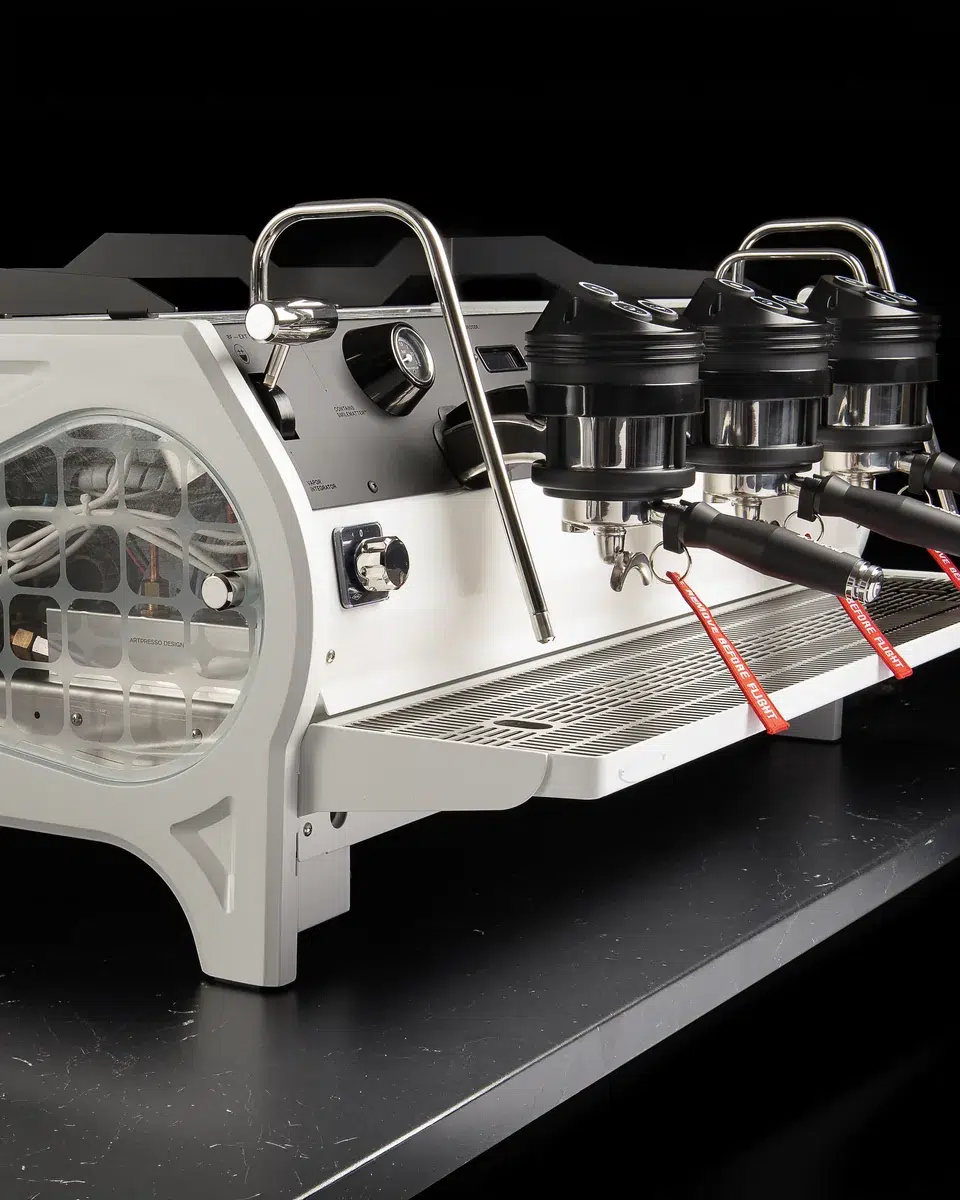 Custom BIGFACE La Marzocco Strada from the side, the round glass window revealing the internals beside the three group heads and white drip tray